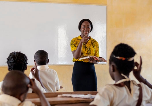 Teacher standing in front of her classroom teaching her students